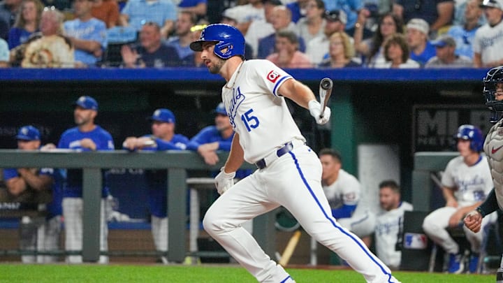 Sep 3, 2024; Kansas City, Missouri, USA; Kansas City Royals third baseman Paul DeJong (15) hits a one-run sacrifice against the Cleveland Guardians in the sixth inning at Kauffman Stadium. Mandatory Credit: Denny Medley-Imagn Images