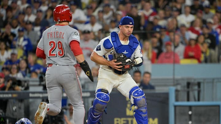Oct 1, 2025; Los Angeles, California, USA; Los Angeles Dodgers catcher Ben Rortvedt (47) fields a throw to get an out Cincinnati Reds center fielder TJ Friedl (29) at home plate in the sixth inning during game two of the Wildcard round for the 2025 MLB playoffs at Dodger Stadium. Mandatory Credit: Jayne Kamin-Oncea-Imagn Images