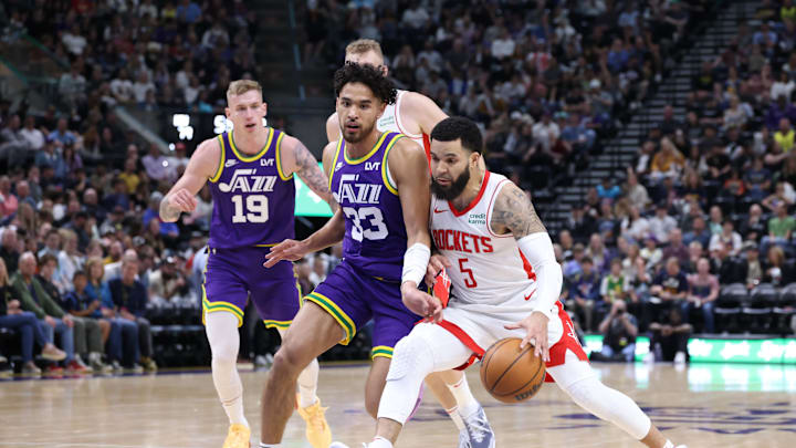Apr 11, 2024; Salt Lake City, Utah, USA; Houston Rockets guard Fred VanVleet (5) drives against Utah Jazz guard Johnny Juzang (33) during the third quarter at Delta Center. Mandatory Credit: Rob Gray-Imagn Images