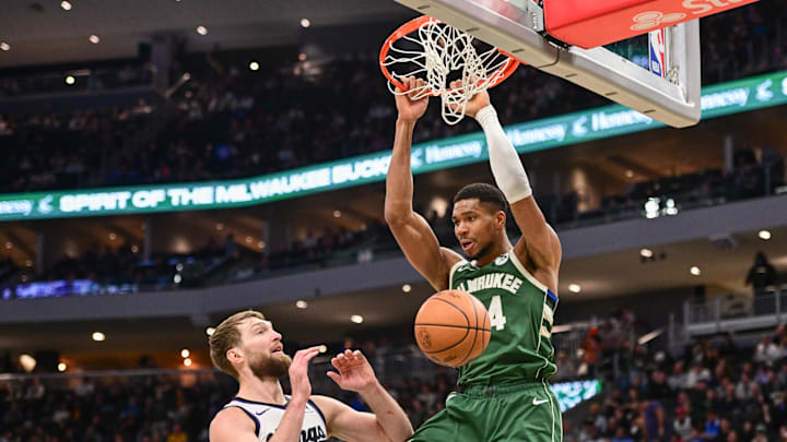 Jan 14, 2025; Milwaukee, Wisconsin, USA; Milwaukee Bucks forward Giannis Antetokounmpo (34) dunks the ball against Sacramento Kings center Domantas Sabonis (11) in the third quarter at Fiserv Forum. Mandatory Credit: Benny Sieu-Imagn Images