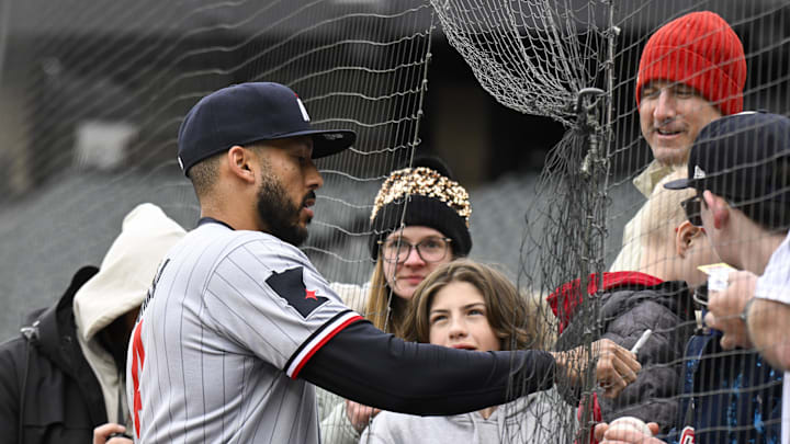 Mar 31, 2025; Chicago, Illinois, USA;  Minnesota Twins shortstop Carlos Correa (4) signs autographs for fans before the teams game against the Chicago White Sox at Guaranteed Rate Field. Mandatory Credit: Matt Marton-Imagn Images