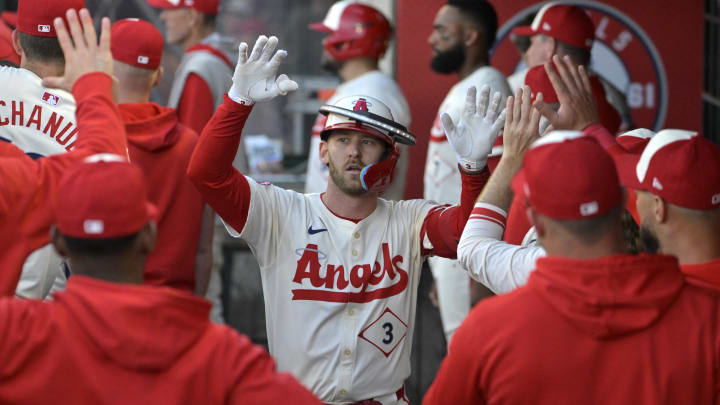 Jun 24, 2024; Anaheim, California, USA; Los Angeles Angels left fielder Taylor Ward (3) is congratulated in the dugout after hitting a two-run home run in the first inning against the Oakland Athletics at Angel Stadium. Jun 24, 2024; Anaheim, California, USA; Los Angeles Angels left fielder Taylor Ward (3) is congratulated in the dugout after hitting a two-run home run in the first inning against the Oakland Athletics at Angel Stadium.