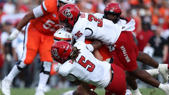 Aug 29, 2026; Charlottesville, Virginia, USA; North Carolina State Wolfpack linebacker LaCorian Hodge (35) and linebacker Harvey Dyson III (5) sack Virginia Cavaliers quarterback Beau Pribula (7) during the second quarter of the game against the Virginia Cavaliers at Scott Stadium. Mandatory Credit: Greg Atkins-Imagn Images Aug 29, 2026; Charlottesville, Virginia, USA; North Carolina State Wolfpack linebacker LaCorian Hodge (35) and linebacker Harvey Dyson III (5) sack Virginia Cavaliers quarterback Beau Pribula (7) during the second quarter of the game against the Virginia Cavaliers at Scott Stadium. Mandatory Credit: Greg Atkins-Imagn Images