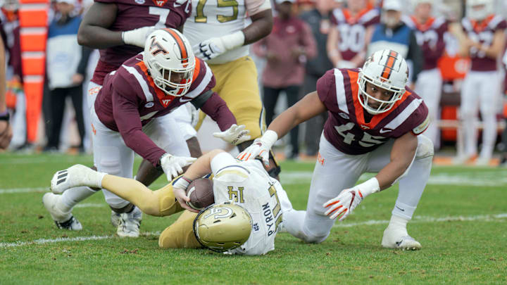 Nov 5, 2022; Blacksburg, Virginia, USA; Virginia Tech Hokies defensive lineman Jaylen Griffin (41) and Virginia Tech Hokies defensive lineman sack Virginia Tech Hokies defensive lineman TyJuan Garbutt (45) sack Georgia Tech Yellow Jackets quarterback Zach Pyron (14)  in the firsbhalf at Lane Stadium. Mandatory Credit: Lee Luther Jr.-Imagn Images