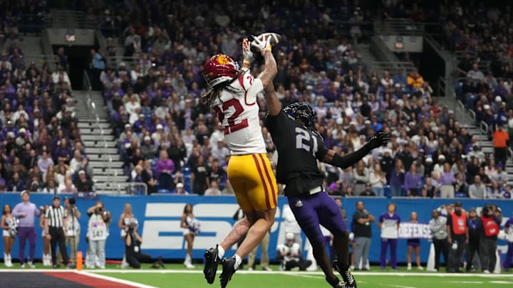 Dec 30, 2025; San Antonio, TX, USA; Southern California Trojans running back Bryan Jackson (21) attempts to catch the ball against TCU Horned Frogs safety Bud Clark (21) in the first half during the Alamo Bowl at Alamodome. Mandatory Credit: Kirby Lee-Imagn Images