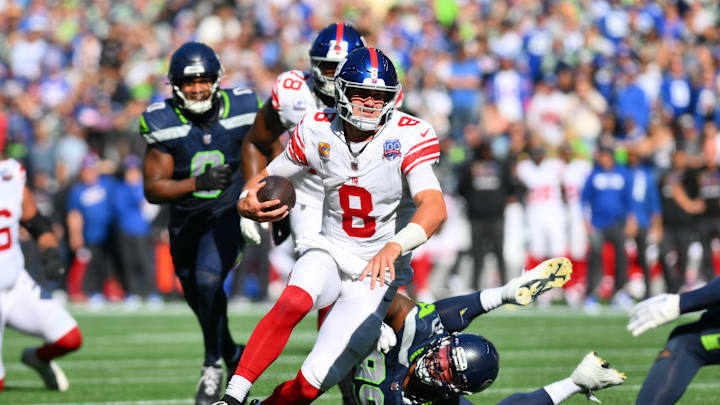 Oct 6, 2024; Seattle, Washington, USA; New York Giants quarterback Daniel Jones (8) carries the ball against the Seattle Seahawks during the first half at Lumen Field.  