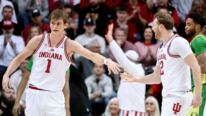 Indiana Hoosiers forward Reed Bailey (1) high-fives Indiana Hoosiers forward Tucker DeVries (12) 