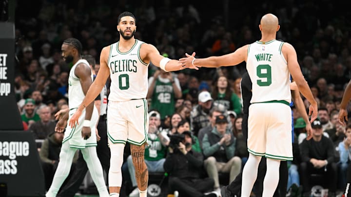 Jan 17, 2025; Boston, Massachusetts, USA; Boston Celtics forward Jayson Tatum (0) reacts to game play with guard Derrick White (9) during the first half against the Orlando Magic at TD Garden. Mandatory Credit: Eric Canha-Imagn Images Jan 17, 2025; Boston, Massachusetts, USA; Boston Celtics forward Jayson Tatum (0) reacts to game play with guard Derrick White (9) during the first half against the Orlando Magic at TD Garden. Mandatory Credit: Eric Canha-Imagn Images