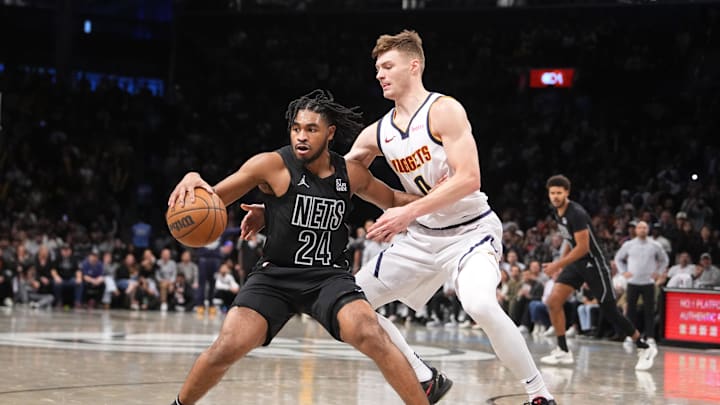 Oct 29, 2024; Brooklyn, New York, USA; Brooklyn Nets small guard Cam Thomas (24) dribbles the ball against Denver Nuggets guard Christian Braun (0) during the second half at Barclays Center. Mandatory Credit: Gregory Fisher-Imagn Images