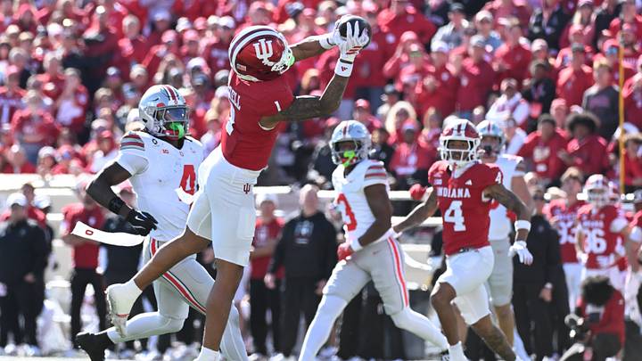 Oct 17, 2026; Bloomington, Indiana, USA;  Indiana Hoosiers defensive back Amare Ferrell (1) intercepts a pass  in front of Ohio State Buckeyes wide receiver Jeremiah Smith (4) during the second half at Merchants Bank Field at Memorial Stadium.  Mandatory Credit: Robert Goddin-Imagn Images