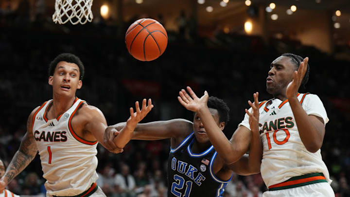 Feb 25, 2025; Coral Gables, Florida, USA;  Miami (Fl) Hurricanes center Lynn Kidd (1), Duke Blue Devils center Patrick Ngongba II (21) and guard Paul Djobet (10) battle for a rebound during the first half at Watsco Center. Mandatory Credit: Jim Rassol-Imagn Images