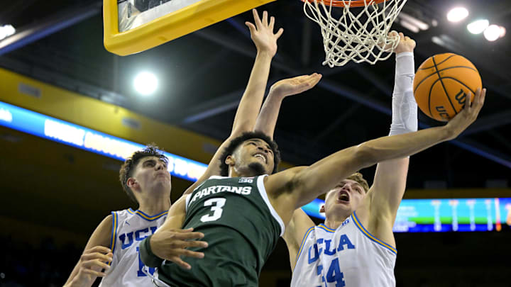 Michigan State Spartans guard Jaden Akins scores past the defense of UCLA Bruins center Aday Mara and forward Tyler Bilodeau. Mandatory Credit: Jayne Kamin-Oncea-Imagn Images