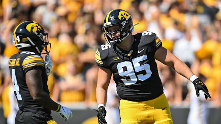 Sep 2, 2023; Iowa City, Iowa, USA; Iowa Hawkeyes defensive lineman Aaron Graves (95) and running back Leshon Williams (4) in action during the game against the Utah State Aggies at Kinnick Stadium. Mandatory Credit: Jeffrey Becker-Imagn Images Sep 2, 2023; Iowa City, Iowa, USA; Iowa Hawkeyes defensive lineman Aaron Graves (95) and running back Leshon Williams (4) in action during the game against the Utah State Aggies at Kinnick Stadium. Mandatory Credit: Jeffrey Becker-Imagn Images