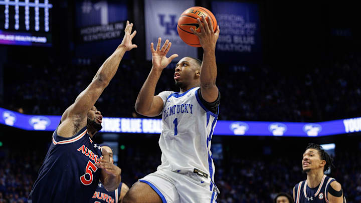 Mar 1, 2025; Lexington, Kentucky, USA; Kentucky Wildcats guard Lamont Butler (1) goes to the basket against Auburn Tigers forward Chris Moore (5) during the second half at Rupp Arena at Central Bank Center. Mandatory Credit: Jordan Prather-Imagn Images
