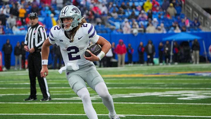 Oct 25, 2025; Lawrence, Kansas, USA; Kansas State Wildcats quarterback Avery Johnson (2) runs the ball against the Kansas Jayhawks during the second half of the game at David Booth Kansas Memorial Stadium. Mandatory Credit: Denny Medley-Imagn Images