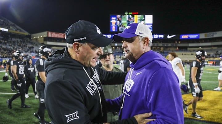 West Virginia Mountaineers head coach Rich Rodriguez talks with Texas Christian University Horned Frogs head coach Sonny Dykes after the game at Milan Puskar Stadium. West Virginia Mountaineers head coach Rich Rodriguez talks with Texas Christian University Horned Frogs head coach Sonny Dykes after the game at Milan Puskar Stadium.