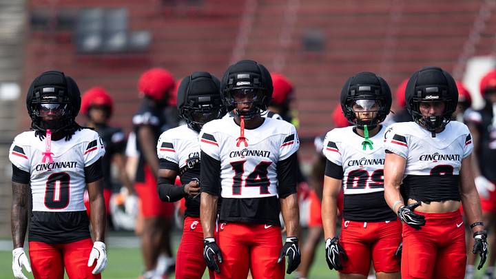 Cincinnati Bearcats Wide Receiver Isaiah Johnson (0), Cincinnati Bearcats Wide Receiver Elijah Janes (14) and Cincinnati Bearcats Running Back Cade Wolford (8) look on during the Cincinnati Bearcats football practice at Nippert Stadium in Cincinnati on Saturday, Aug. 8, 2026. Cincinnati Bearcats Wide Receiver Isaiah Johnson (0), Cincinnati Bearcats Wide Receiver Elijah Janes (14) and Cincinnati Bearcats Running Back Cade Wolford (8) look on during the Cincinnati Bearcats football practice at Nippert Stadium in Cincinnati on Saturday, Aug. 8, 2026.