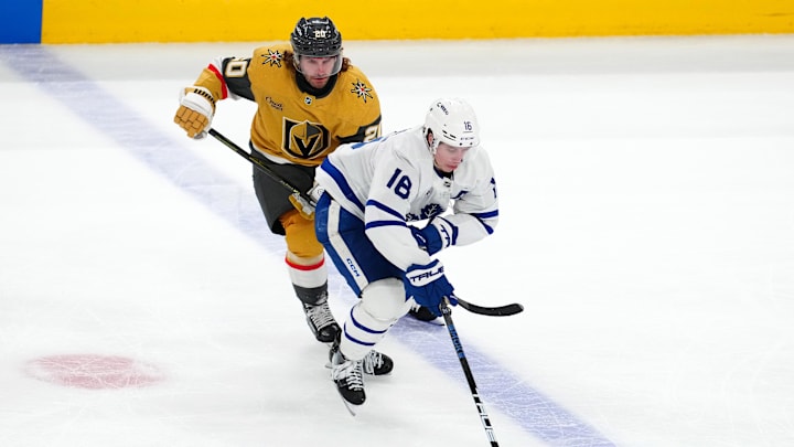 Mar 5, 2025; Las Vegas, Nevada, USA; Toronto Maple Leafs right wing Mitch Marner (16) skates ahead of Vegas Golden Knights left wing Brandon Saad (20) during the third period at T-Mobile Arena. Mandatory Credit: Stephen R. Sylvanie-Imagn Images