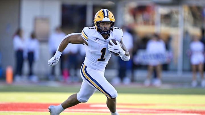 Nov 30, 2024; Dallas, Texas, USA; California Golden Bears running back Jaydn Ott (1) runs with the ball against the Southern Methodist Mustangs during the first half at Gerald J. Ford Stadium. Mandatory Credit: Jerome Miron-Imagn Images