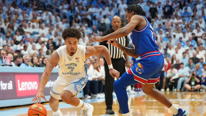 Nov 7, 2025; Chapel Hill, North Carolina, USA;  North Carolina Tar Heels guard Seth Trimble (7) with the ball as Kansas Jayhawks guard Elmarko Jackson (13) defends in the second half at Dean E. Smith Center. Mandatory Credit: Bob Donnan-Imagn Images