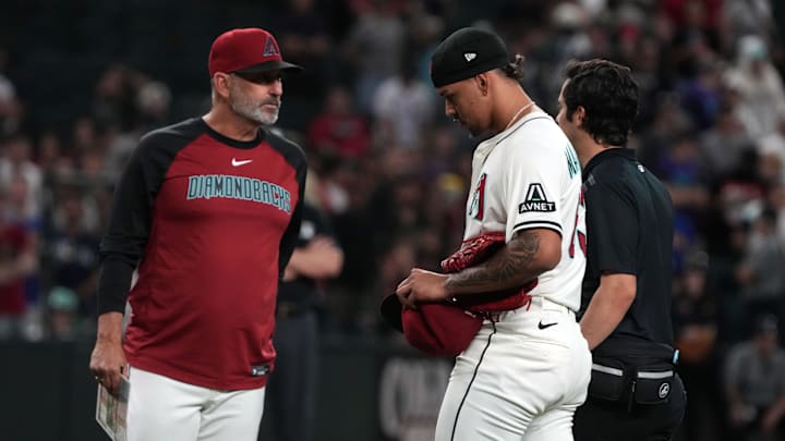 Jun 9, 2025; Phoenix, Arizona, USA; Arizona Diamondbacks pitcher Justin Martinez (63) leaves the game after an injury against the Seattle Mariners in the ninth inning at Chase Field. Mandatory Credit: Rick Scuteri-Imagn Images