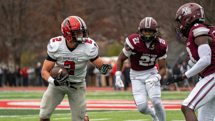Marcello Vitti (2) of Divine Child runs the ball against the Harper Woods defense during a Division 4 regional final at John Glenn High School in Westland on Saturday, Nov. 15, 2025. Marcello Vitti (2) of Divine Child runs the ball against the Harper Woods defense during a Division 4 regional final at John Glenn High School in Westland on Saturday, Nov. 15, 2025.