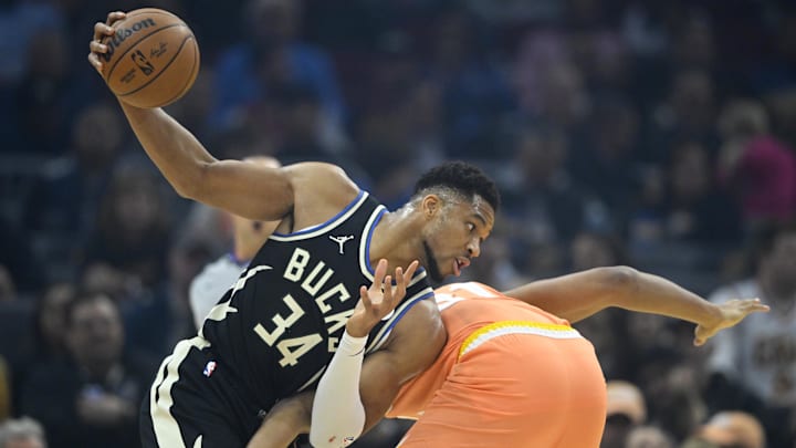 Nov 17, 2025; Cleveland, Ohio, USA; Milwaukee Bucks forward Giannis Antetokounmpo (34) holds the ball beside Cleveland Cavaliers center Jarrett Allen (31) in the first quarter at Rocket Arena. Mandatory Credit: David Richard-Imagn Images