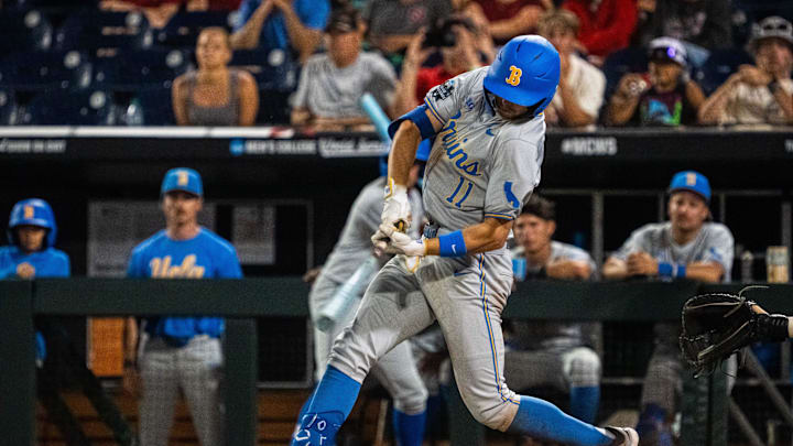 Jun 17, 2025; Omaha, Neb, USA; UCLA Bruins center fielder Payton Brennan (11) hits a RBI single against the Arkansas Razorbacks during the ninth inning at Charles Schwab Field. Mandatory Credit: Dylan Widger-Imagn Images Jun 17, 2025; Omaha, Neb, USA; UCLA Bruins center fielder Payton Brennan (11) hits a RBI single against the Arkansas Razorbacks during the ninth inning at Charles Schwab Field. Mandatory Credit: Dylan Widger-Imagn Images