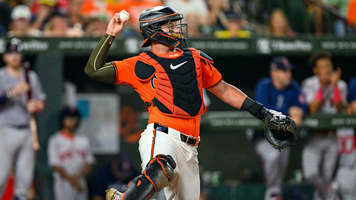 Aug 17, 2024; Baltimore, Maryland, USA; Baltimore Orioles catcher James McCann (27) throws the ball during the fifth inning against the Boston Red Sox at Oriole Park at Camden Yards. Mandatory Credit: Reggie Hildred-Imagn Images
