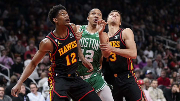 Apr 21, 2023; Atlanta, Georgia, USA; Boston Celtics forward Grant Williams (12) waits for a rebound between Atlanta Hawks forward De'Andre Hunter (12) and guard Bogdan Bogdanovic (13) during the first half during game three of the 2023 NBA playoffs at State Farm Arena. Mandatory Credit: Dale Zanine-Imagn Images