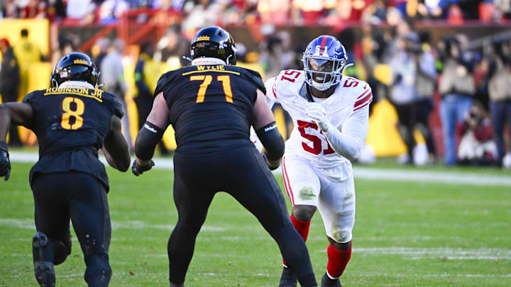 Nov 19, 2023; Landover, Maryland, USA; New York Giants linebacker Azeez Ojulari (51) rushes as Washington Commanders guard Andrew Wylie (71) blocks during the second half at FedExField. Mandatory Credit: Brad Mills-Imagn Images