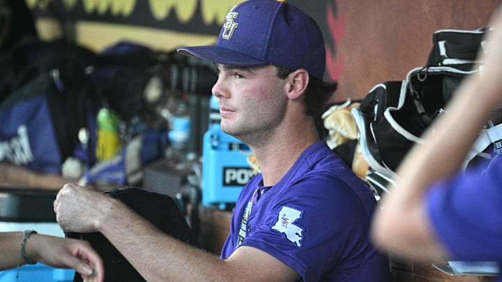 Jun 21, 2025; Omaha, Neb, USA; LSU Tigers starting pitcher Kade Anderson (32) sits in the dugout between the eighth and ninth innings against the Coastal Carolina Chanticleers at Charles Schwab Field. Mandatory Credit: Steven Branscombe-Imagn Images Jun 21, 2025; Omaha, Neb, USA; LSU Tigers starting pitcher Kade Anderson (32) sits in the dugout between the eighth and ninth innings against the Coastal Carolina Chanticleers at Charles Schwab Field. Mandatory Credit: Steven Branscombe-Imagn Images