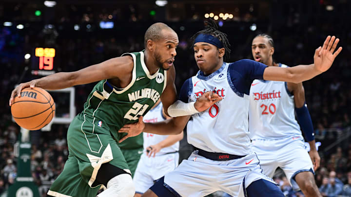 Dec 21, 2024; Milwaukee, Wisconsin, USA; Milwaukee Bucks forward Khris Middleton (22) drives to the basket against Washington Wizards forward Bilal Coulibaly (0) in the first quarter at Fiserv Forum. Mandatory Credit: Benny Sieu-Imagn Images