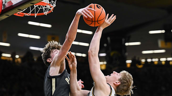 Feb 14, 2026; Iowa City, Iowa, USA; Purdue Boilermakers center Daniel Jacobsen (12) blocks the shot of Iowa Hawkeyes forward Cooper Koch (8) during the second half at Carver-Hawkeye Arena. Mandatory Credit: Jeffrey Becker-Imagn Images