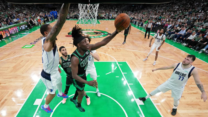 Jun 9, 2024; Boston, Massachusetts, USA; Boston Celtics guard Jrue Holiday (4) shoots the ball against Dallas Mavericks forward P.J. Washington (left) during the second quarter in game two of the 2024 NBA Finals at TD Garden. Mandatory Credit: Peter Casey-USA TODAY Sports