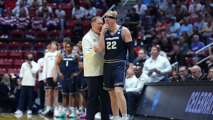 Mar 20, 2026; San Diego, CA, USA; Utah State Aggies head coach Jerrod Calhoun talks with forward Karson Templin (22) in the second half against the Villanova Wildcats during a first round game of the men's 2026 NCAA Tournament at Viejas Arena. Mandatory Credit: Kirby Lee-Imagn Images