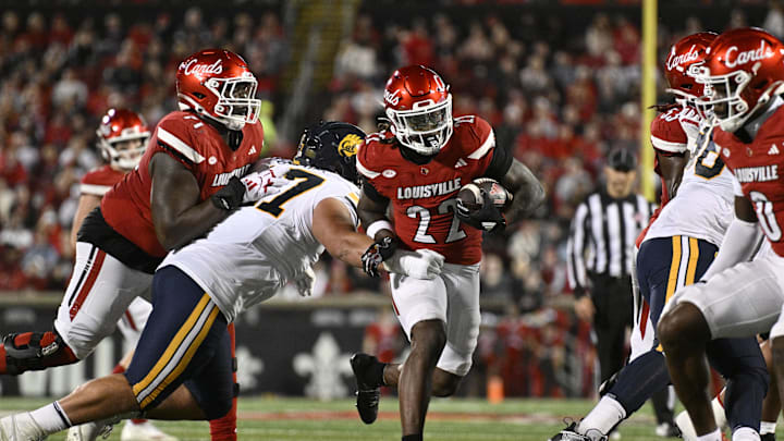 Nov 8, 2025; Louisville, Kentucky, USA;  Louisville Cardinals running back Keyjuan Brown (22) runs the ball against California Golden Bears defensive lineman Aidan Keanaaina (47) during the first half at L&N Federal Credit Union Stadium. Mandatory Credit: Jamie Rhodes-Imagn Images