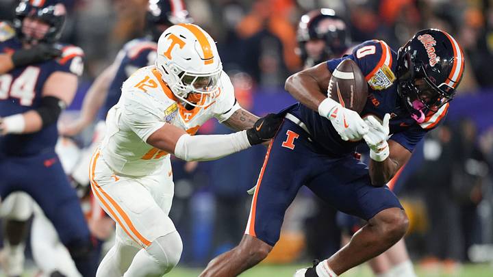 Illinois wide receiver Justin Bowick (0) trie to bring in the ball while defended by Tennessee quarterback Tennessee linebacker Jaedon Harmon (12) during the Music City Bowl NCAA college football game on Dec. 30, 2025, in Nashville, Tennessee. Illinois wide receiver Justin Bowick (0) trie to bring in the ball while defended by Tennessee quarterback Tennessee linebacker Jaedon Harmon (12) during the Music City Bowl NCAA college football game on Dec. 30, 2025, in Nashville, Tennessee.