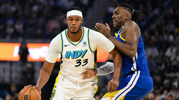 Dec 23, 2024; San Francisco, California, USA; Indiana Pacers center Myles Turner (33) dribbles against Golden State Warriors forward Kevon Looney (5) in the first quarter at Chase Center. Mandatory Credit: Eakin Howard-Imagn Images