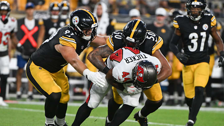 Aug 16, 2025; Pittsburgh, Pennsylvania, USA; Pittsburgh Steelers linebacker Malik Harrison (50) and defensive tackle Logan Lee (91) tackle Tampa Bay Buccaneers running back Sean Tucker (44) during the second half at Acrisure Stadium. Mandatory Credit: Barry Reeger-Imagn Images