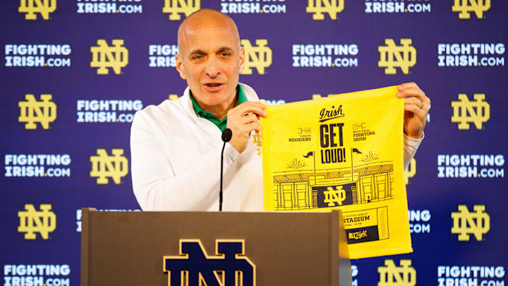 During a Dec. 17 press conference, Notre Dame Athletic Director Pete Bevacqua holds up one of the towels that will be handed out during Notre Dame football's game against Indiana in the first round of the College Football Playoff at Notre Dame Stadium on Friday, Dec. 20, 2024.