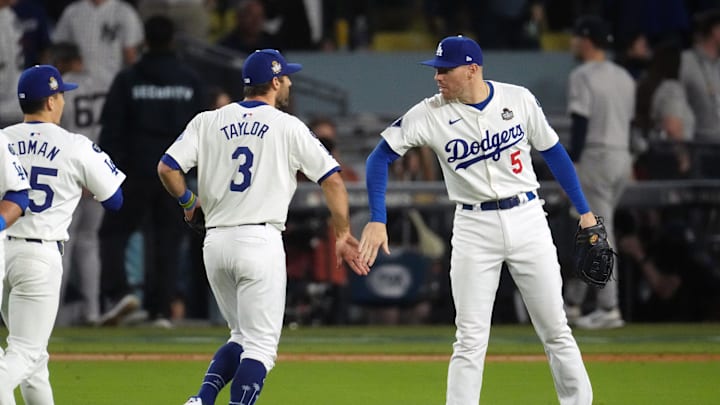 Oct 26, 2024; Los Angeles, California, USA; Los Angeles Dodgers first baseman Freddie Freeman (5) and outfielder Chris Taylor (3) celebrate after defeating the New York Yankees during game two of the 2024 MLB World Series at Dodger Stadium. Mandatory Credit: Kirby Lee-Imagn Images