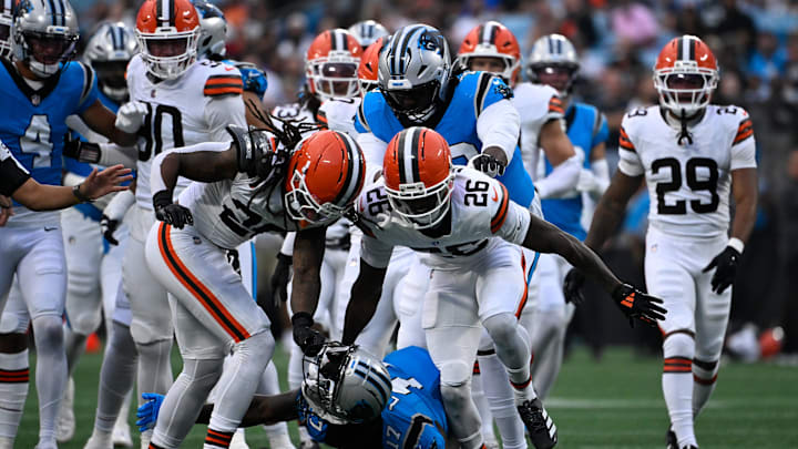 Aug 8, 2025; Charlotte, North Carolina, USA; Cleveland Browns safety Rayshawn Jenkins (28) rips off Carolina Panthers wide receiver Xavier Legette (17) helmet in the first quarter at Bank of America Stadium. Both players were ejected on the play. Mandatory Credit: Bob Donnan-Imagn Images