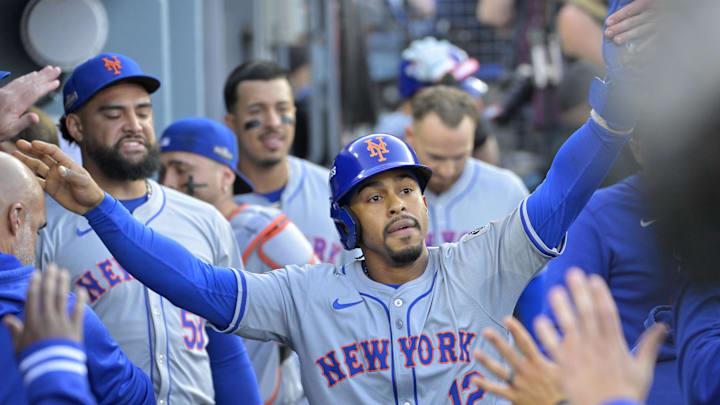 Oct 20, 2024; Los Angeles, California, USA; New York Mets shortstop Francisco Lindor (12) celebrates in the dugout after scoring in the first inning against the Los Angeles Dodgers during game six of the NLCS for the 2024 MLB playoffs at Dodger Stadium. 