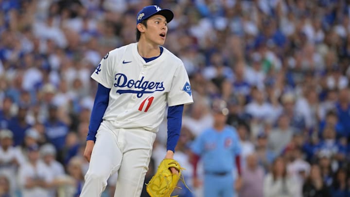 Oct 9, 2025; Los Angeles, California, USA; Los Angeles Dodgers pitcher Roki Sasaki (11) reacts after the tenth inning against the Philadelphia Phillies during game four of the NLDS round for the 2025 MLB playoffs at Dodger Stadium. Mandatory Credit: Jayne Kamin-Oncea-Imagn Images