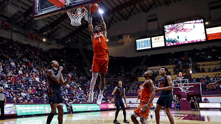 Jan 4, 2025; Blacksburg, Virginia, USA; Virginia Tech Hokies forward Tobi Lawal (1) dunks the ball against Miami Hurricanes guard Matthew Cleveland (0) during the first half at Cassell Coliseum. Mandatory Credit: Peter Casey-Imagn Images Jan 4, 2025; Blacksburg, Virginia, USA; Virginia Tech Hokies forward Tobi Lawal (1) dunks the ball against Miami Hurricanes guard Matthew Cleveland (0) during the first half at Cassell Coliseum. Mandatory Credit: Peter Casey-Imagn Images