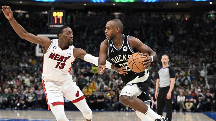 Apr 16, 2023; Milwaukee, Wisconsin, USA; Milwaukee Bucks forward Khris Middleton (22) drives to the basket against Miami Heat center Bam Adebayo (13) in the second half during game one of the 2023 NBA Playoffs at Fiserv Forum. Mandatory Credit: Michael McLoone-USA TODAY Sports Apr 16, 2023; Milwaukee, Wisconsin, USA; Milwaukee Bucks forward Khris Middleton (22) drives to the basket against Miami Heat center Bam Adebayo (13) in the second half during game one of the 2023 NBA Playoffs at Fiserv Forum. Mandatory Credit: Michael McLoone-USA TODAY Sports