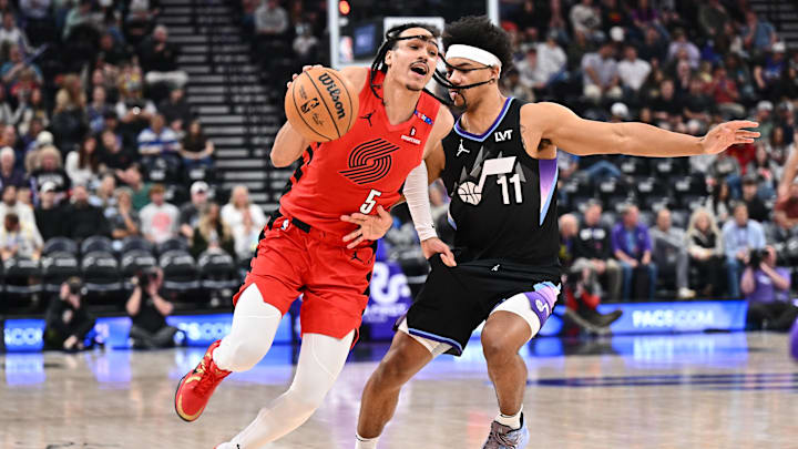Portland Trail Blazers guard Dalano Banton drives around the defense of Utah Jazz guard Jaden Springer. Mandatory Credit: Jamie Sabau-Imagn Images