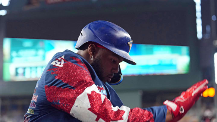Jul 14, 2024; Phoenix, Arizona, USA; Toronto Blue Jays first base Vladimir Guerrero Jr. (27) celebrates with a custom jacket after hitting a solo run home run against the Arizona Diamondbacks during the seventh inning at Chase Field. Mandatory Credit: Joe Camporeale-USA TODAY Sports