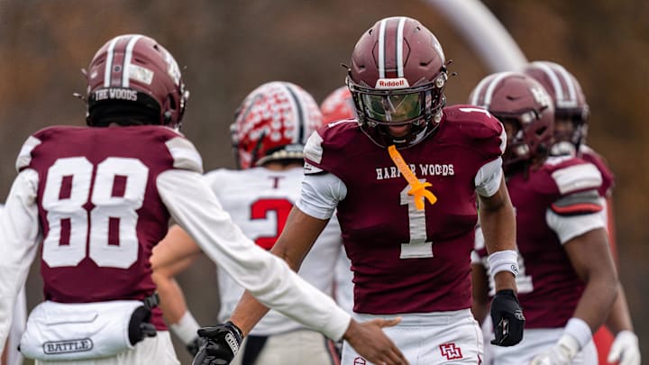 Harper Woods wide receiver Dakota Guerrant (1) celebrates with his teammate after scoring a touchdown during a Division 4 regional final against Divine Child High School at John Glenn High School in Westland on Saturday, Nov. 15, 2025.